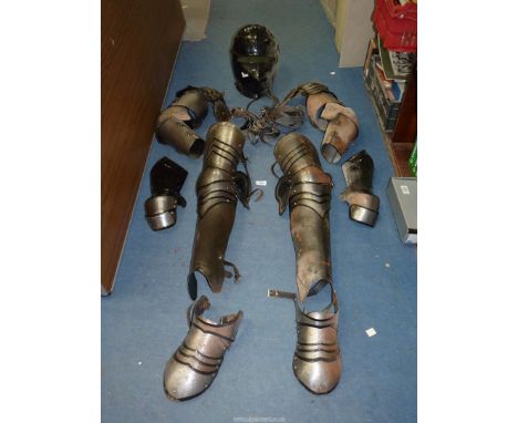 A part set of re-enactment Armour including helmet, gauntlets, leg covers, etc.