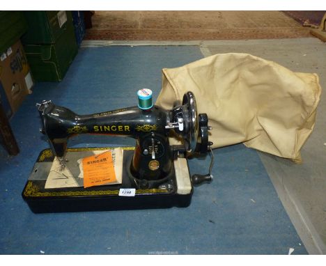 An old manual Singer sewing machine with soft cover.