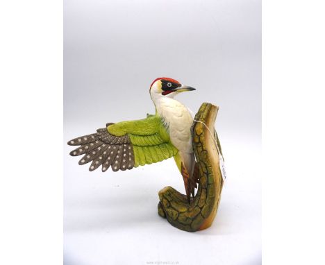 A limited edition figure of a Woodpecker stretching wing on a trunk, no. AP1/15 by Connoisseur of Malvern for H.P. Bulmers Dr