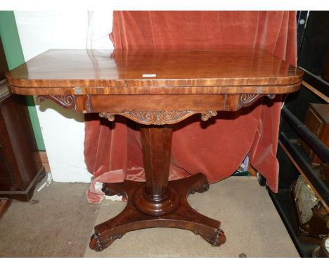 A 19th century Regency design Mahogany flap over card table standing on a tapering octagonal pillar raised on a platform base