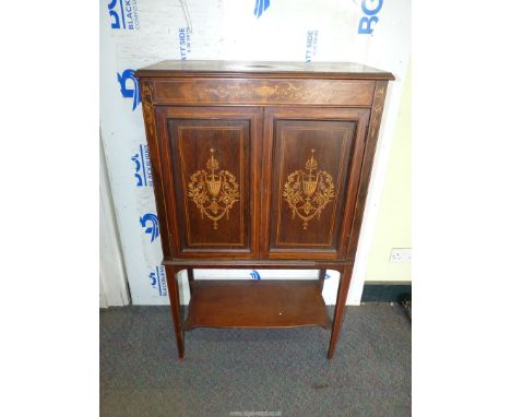 A Rosewood Side Cabinet with Boxwood stringing and elaborate marquetry decoration depicting urns united by a lower shelf, 28 