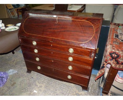 A 19th Century dark Mahogany Bureau, the light and dark-wood strung slope opening to reveal an interior with ten drawers, eig