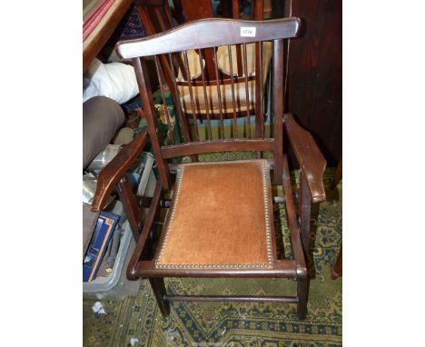 A compact darkwood framed folding open armed Elbow Chair having patent folding action and a brown Draylon upholstered seat.