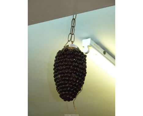 A ceiling light in the form of a bunch of grapes 13" long.