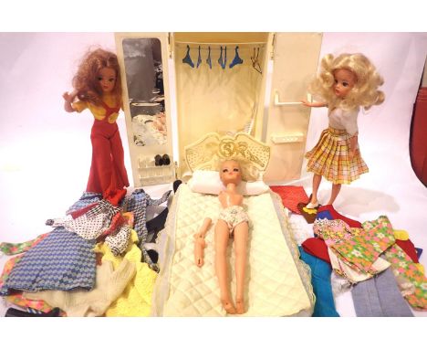 Sindy wardrobe with coat hangers, brush, comb and mirror set, bed and headboard, selection of clothes and shoes and three fur