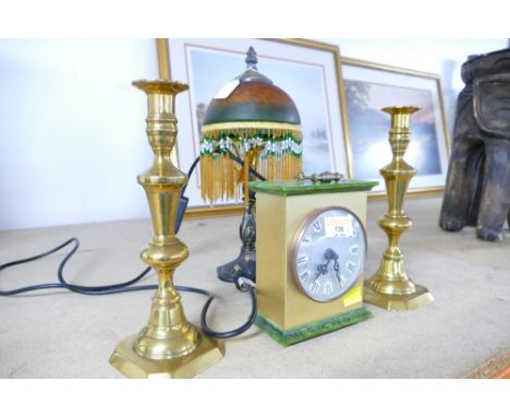 Pair of brass candlesticks, Bentima mantel clock and table lamp with beaded glass shade