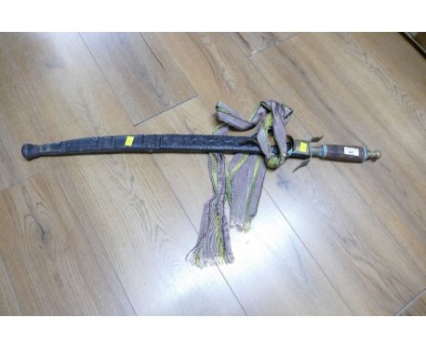Sudanese / tribal sword in sheath   This bladed lot is not for sale to people under the age of 18. By bidding on this item yo