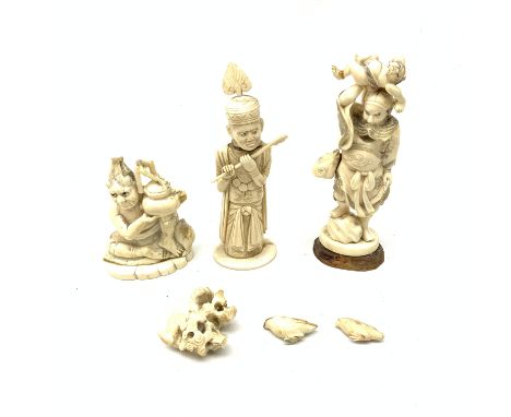 Three Japanese ivory okimonos, the first example modelled as a Sennin type figure holding aloft a smaller figure, H16.5cm, th