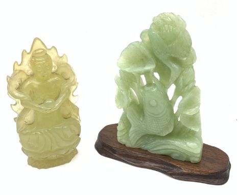 Chinese carved Jade model of Buddha and a green stone carved figure of a fish amongst lotus stems and flowers on hardwood pli