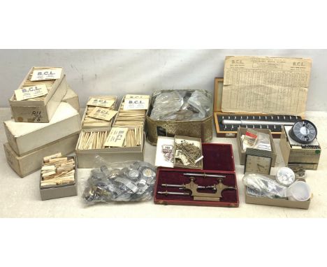 A collection of various watch parts and accessories, to include a large quantity of watch B.C.L. glasses, wrapped in maker's 