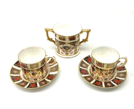 A pair of Royal Crown Derby Imari 1128 coffee cans and saucers, together with a Royal Crown Derby Imari 1128 loving cup, each