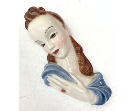 A 20th century American Goldscheider Art Deco wall mask, modelled as a brunette haired female in blue dress, with printed mar