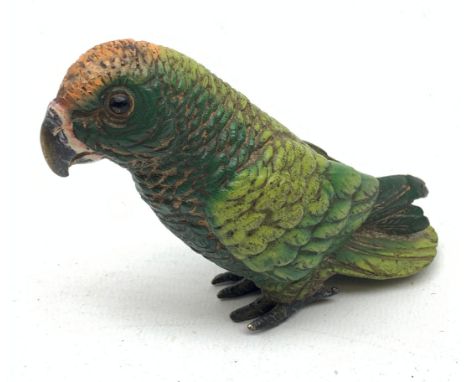 A late 19th century/early 20th century cold painted bronze model of a parrot with variegated green plumage, marked beneath Be
