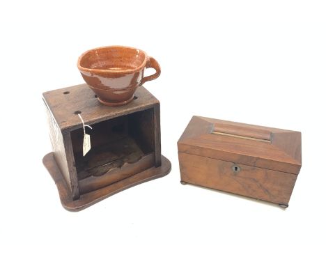 A 19th century mahogany tea caddy, of sarcophagus form and raised upon four compressed bun feet, the hinged cover opening to 