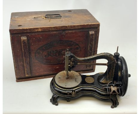 A Vintage Jones hand wind sewing machine, in maker's stamped wooden box.  - Condition Report 