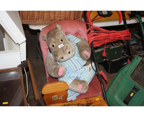 A soft toy hippo and a button backed chair