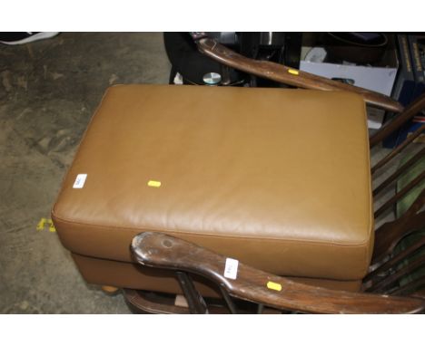 A brown upholstered pouffe