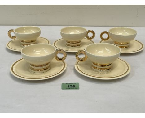 A set of five Art-Deco Robj Paris cups and saucers banded in gilt