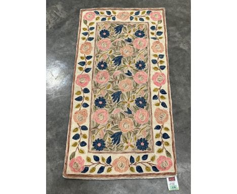 A Kashmiri stitched wool chain rug. 1.1m x 0.58m