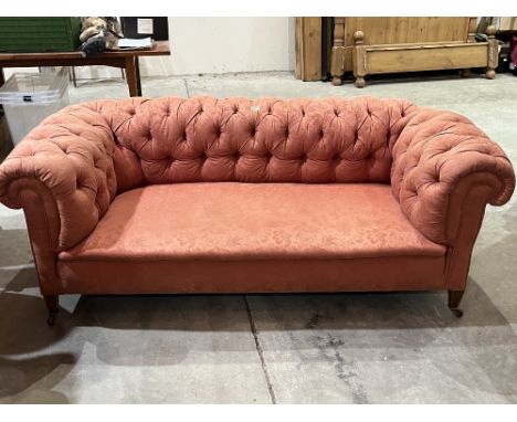 An Edward VII chesterfield sofa with deep buttoned back and arms, on square tapered feet. 72'w