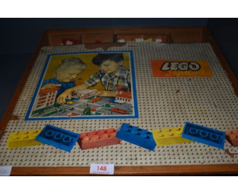 A selection of vintage toy Lego bricks and similar in hand made case
No trees or vehicles