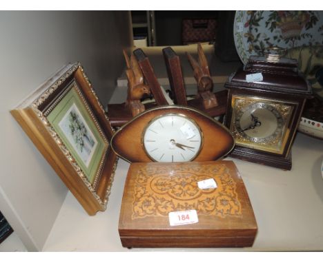 A selection of mantle items including book ends clock and Thorens music box