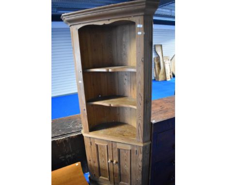 A natural pine corner shelf with cupboard under, height approx. 191cm