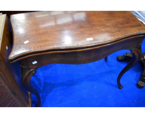 An Edwardian mahogany fold over card table on shaped legs, width approx. 91