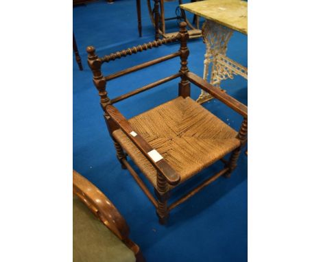 A 19th Century framed armchair having partially bobbin turned frame and strung seat