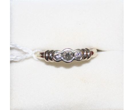 A 9ct white gold three stone diamond ring, collet set with graduated stones