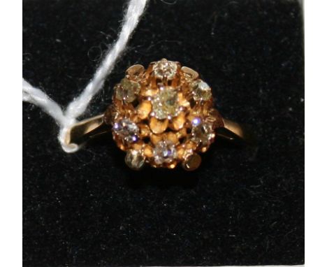 An 18ct gold diamond cluster ring claw set with old cut stones