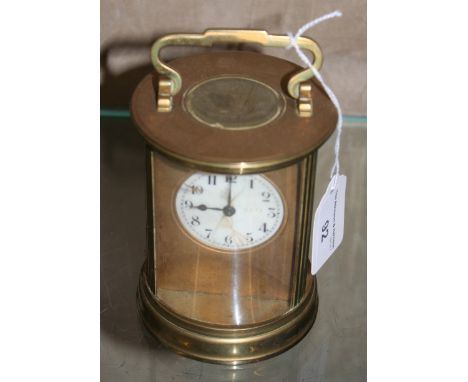 A brass cased circular carriage clock