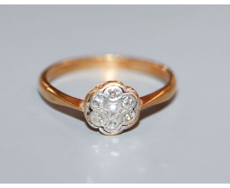 A 1920's 18ct and diamond cluster flower head ring, size R.
