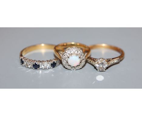 A 18ct and plat, solitaire diamond ring, an 18ct sapphire and diamond ring and a 18ct, white opal and diamond cluster ring.