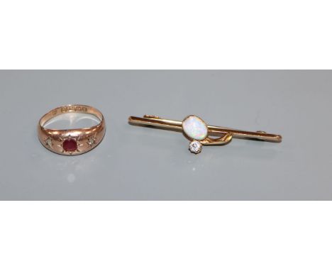 An early 20th century 15ct, white opal and diamond bar brooch and a 9ct gold gypsy set ruby and diamond ring.