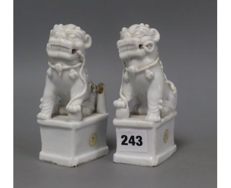 A pair of Chinese blanc de chine Buddhist lion joss-stick holders, losses