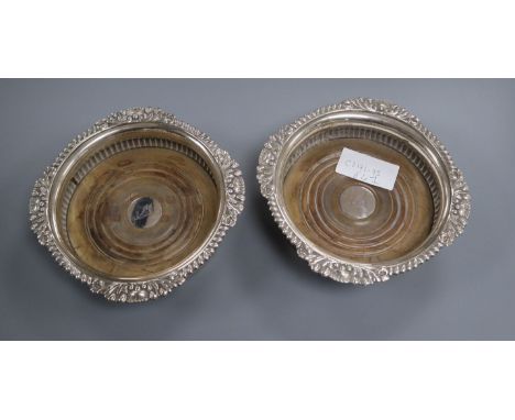 A pair of George IV silver decanter coasters, London 1820 by Samuel Hennell, 16.7 cm.