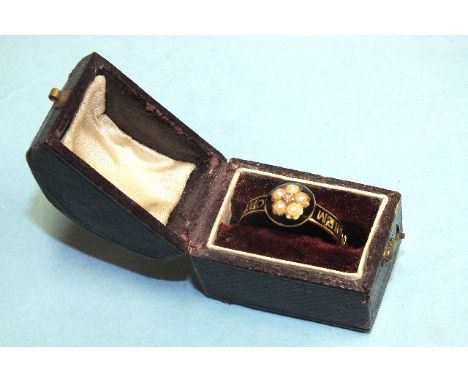 A Victorian mourning ring of 18ct gold with diamond and pearl cluster, the black enamelled shoulders with the words "In Memor