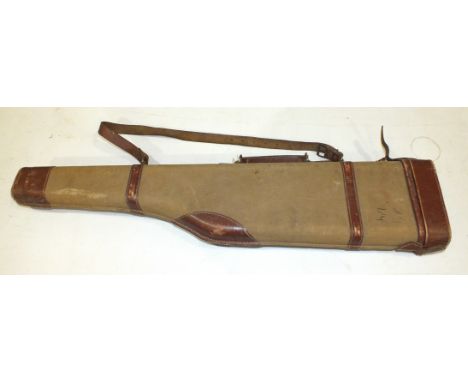 A canvas and leather leg o'mutton gun case by Manufrance, St Etienne, 85cm long and an army great coat, (2).