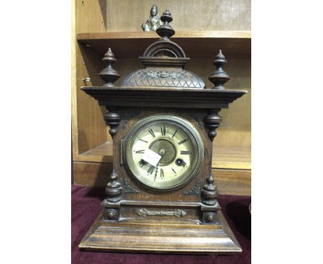 A stained wood-cased mantel clock of architectural form, with Jurgens gong-striking movement, 42cm high.