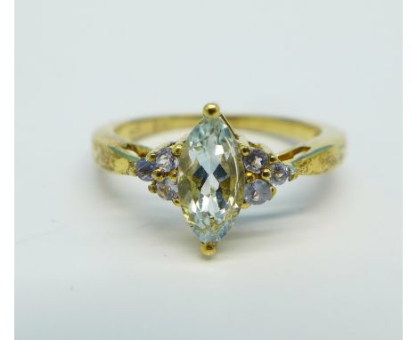 A silver gilt, aquamarine and tanzanite ring, K