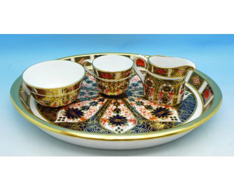 A Royal Crown Derby 1128 pattern tray, miniature cream jug and sugar and a cup