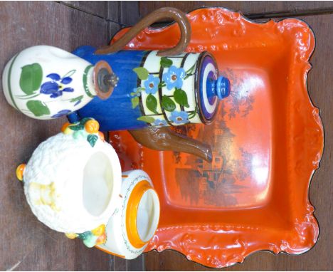A Torquay pottery coffee pot and oil bottle, chip to spout of coffee pot, a Newport Pottery sugar basin, a Clarice Cliff Celt