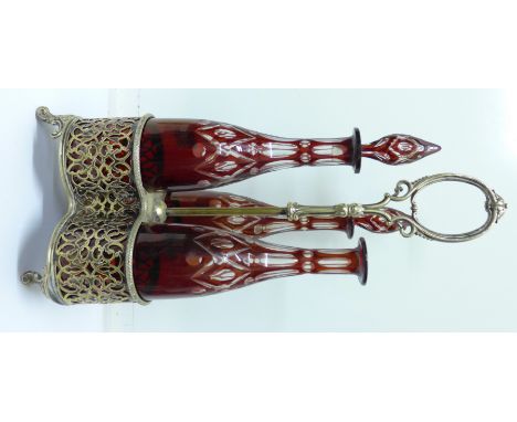 A three-bottle decanter with stand with three ruby glass decanters, one decanter a/f and missing stopper