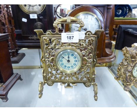 CIRCA 1900 CAST BRASS 'FIRE-SCREEN' FORM BEDROOM MANTEL-SHELF CLOCK, the arabic dial stamped Patented No. 13530, the brass su