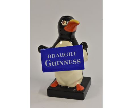 A Carlton Ware Penguin lamp, standing holding a sign, Draught Guinness, 17.5cm high, printed blue mark