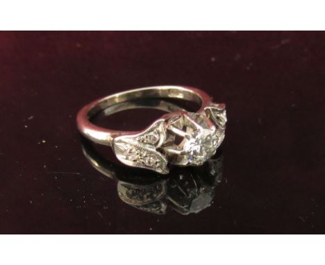 A white gold ring with single .25ct diamond centre, flanked by diamond set shoulders. Size K, 3.3g