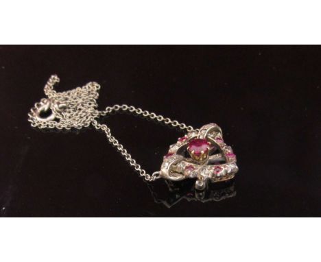 A ruby and diamond heart shaped pendant hung on white metal chain, 40cm long, 5g
