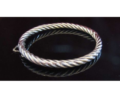 A silver stiff hinge bangle twisted design, 13.9g