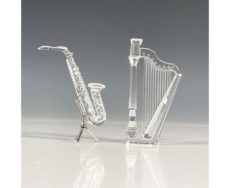 A lead crystal instrument figures comprising of a harp and saxophone with stand. Both were part of the Crystal Melodies and a